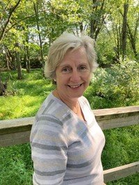 Woman smiling outdoors in forest setting