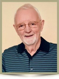 Elderly man smiling with glasses and striped shirt.