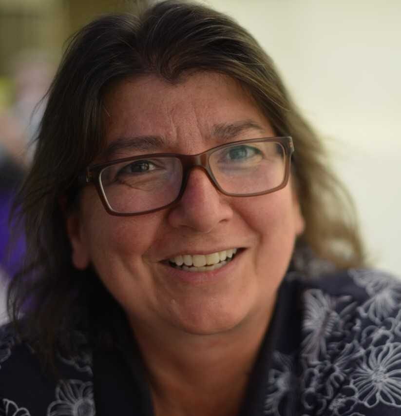 CRAIG, Donna Piccinin-Craig Smiling person with glasses in dark clothing