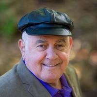 Smiling man in cap outdoors