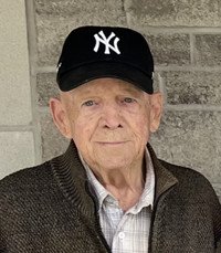 Elderly man wearing New York Yankees cap.