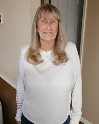 Smiling woman in a white shirt indoors