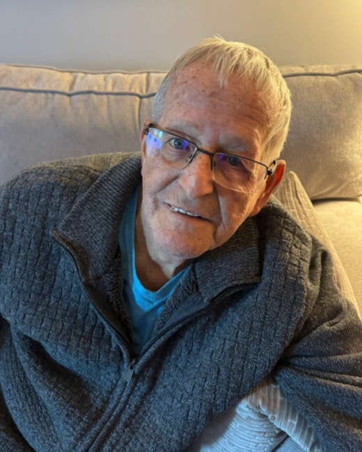 Smiling elderly man sitting on a couch