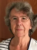 Older woman with glasses and striped shirt