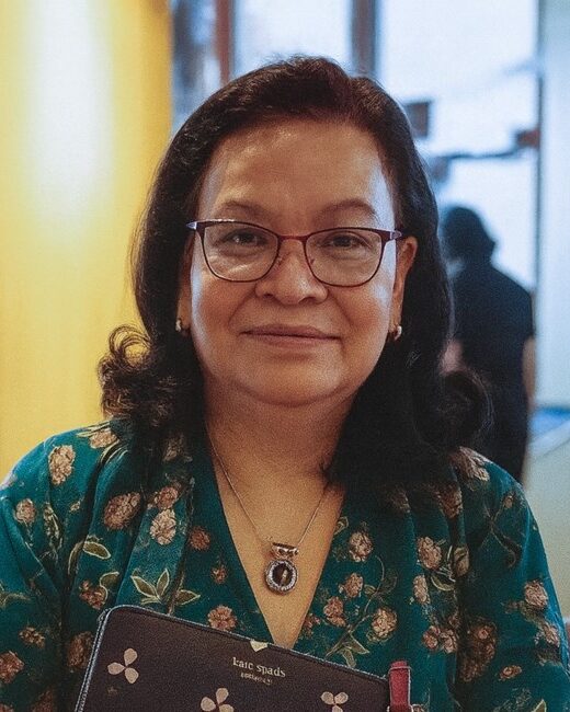 Smiling woman in floral dress with glasses