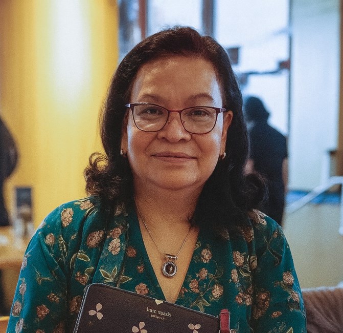 Smiling woman in floral dress with glasses