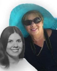 Woman smiling in sunglasses and blue hat
