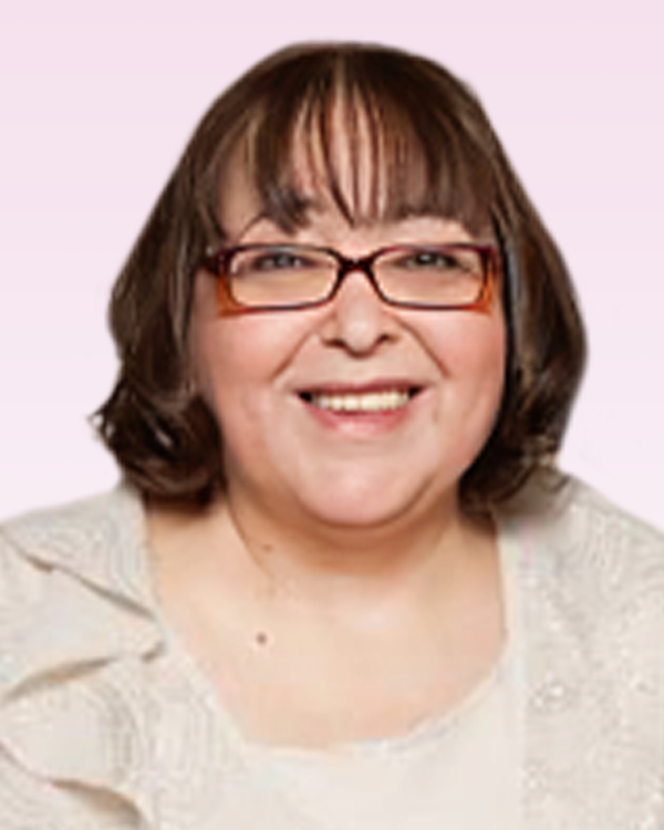 Smiling person with glasses and a white top.