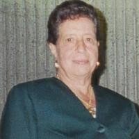 Person in dark suit against striped background