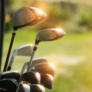 Golf clubs in a sunny course setting