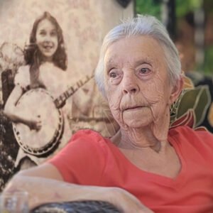 Elderly woman with nostalgic photograph background