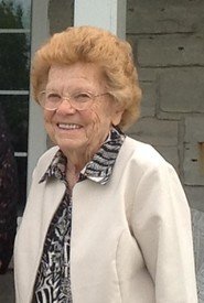 Elderly woman smiling outside house