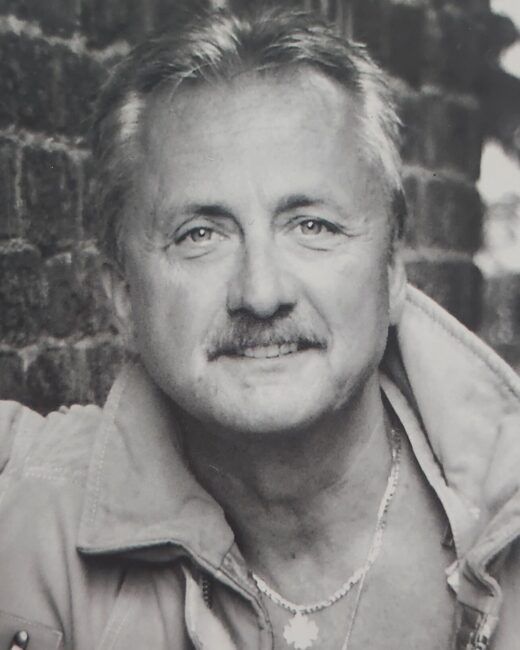 Man smiling in black and white portrait
