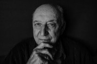 Elderly man pondering in black and white portrait.