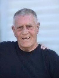 Smiling man in black shirt outdoors