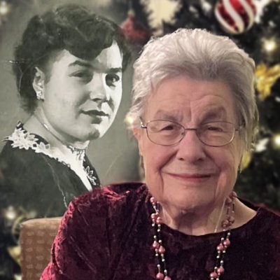 Smiling elderly woman with vintage portrait, Christmas background.