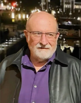 Elderly man with glasses and leather jacket at night