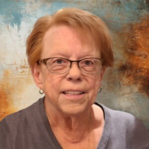 Person with glasses in front of textured background.