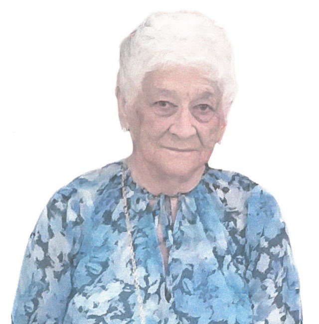 HUT, Helen Hut Elderly woman in blue floral blouse smiling softly.