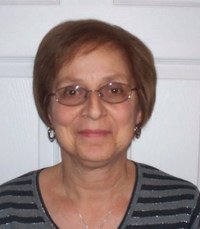 Smiling woman with glasses and striped shirt