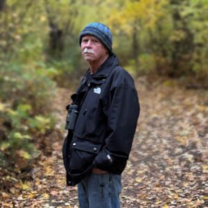 Man walking in autumn forest path