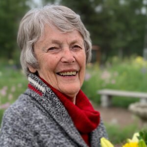 Smiling elderly woman in outdoor garden setting