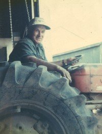 Man driving tractor in a garage