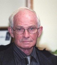 Elderly man wearing glasses and a tie.