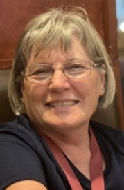 Smiling woman with glasses and gray hair