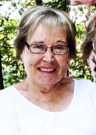 HILLIER, Marilyn Aileen Hillier Smiling woman outdoors wearing glasses and white shirt.