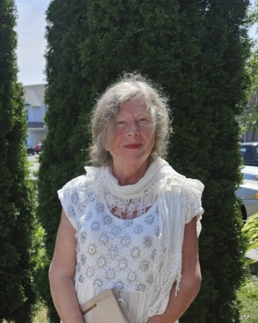Smiling woman in white dress outdoors