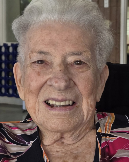 Elderly woman smiling with short white hair