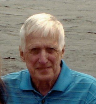 Elderly man smiling by the water