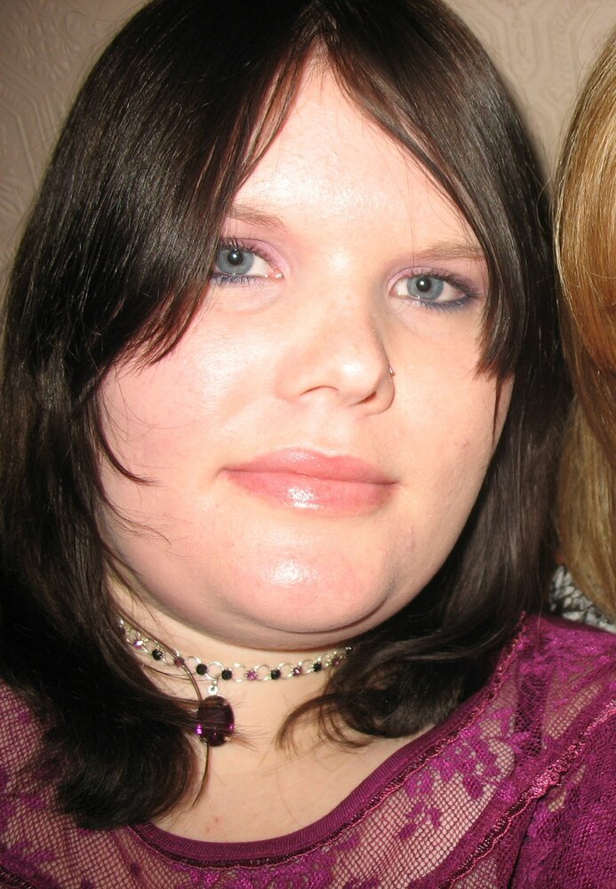Woman wearing purple top and choker necklace