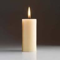 Lit candle with soft glow on dark background.