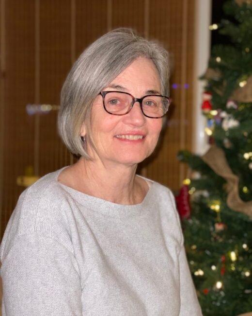 Smiling woman with Christmas tree background