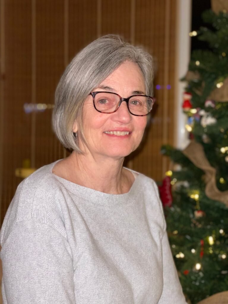 Smiling woman with Christmas tree background
