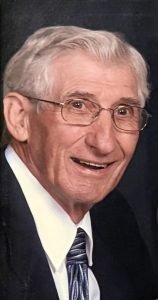 Smiling elderly man in suit and tie portrait.