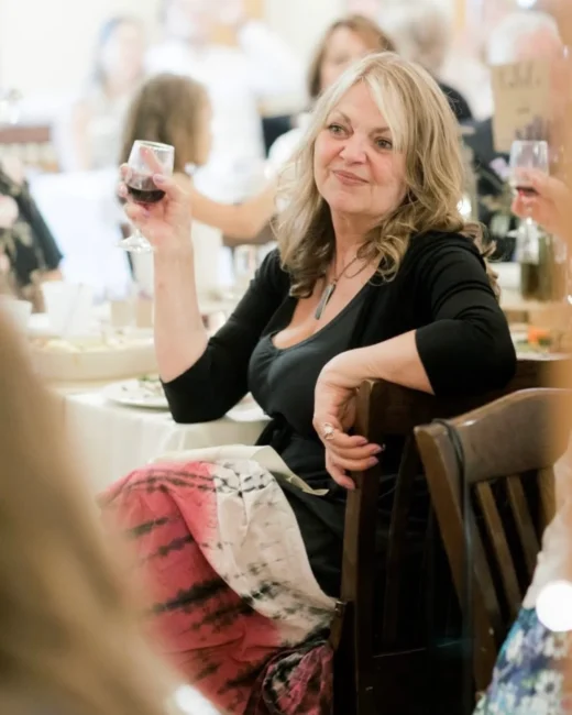 Woman toasting with wine at a celebration