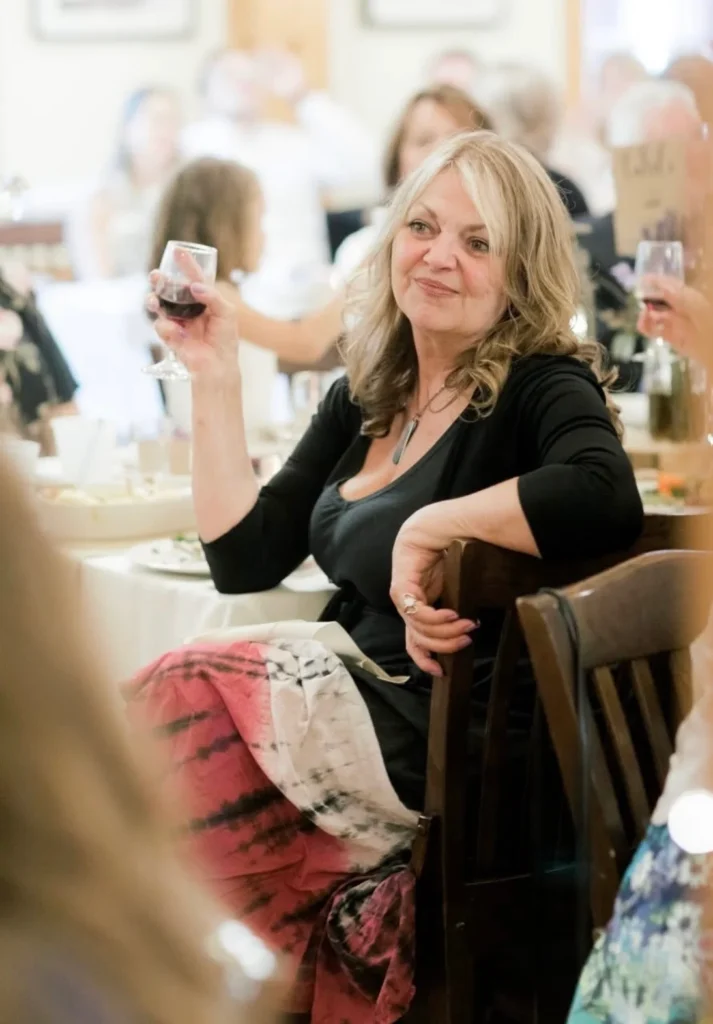Wendy Susan (née Conners) FULLER Woman toasting with wine at a celebration