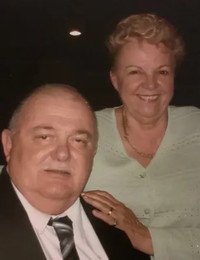 Elderly couple smiling at an event.