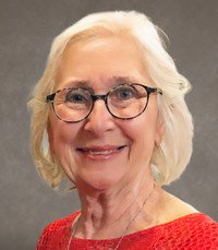 Smiling elderly woman with glasses and white hair