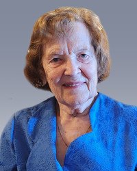 Elderly woman smiling in blue blouse