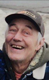 Smiling man wearing a cap outdoors