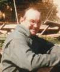 Man sitting outdoors at a park.