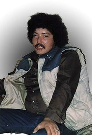 Man wearing winter vest and hat in relaxed pose.
