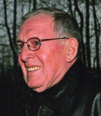 Smiling person in glasses and leather jacket