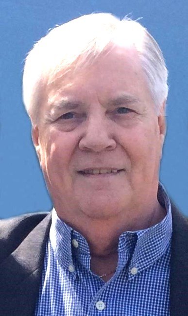 Elderly man with white hair and blue shirt.
