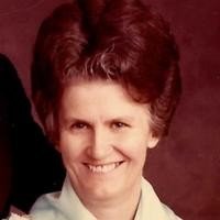Smiling person with vintage hairstyle and attire.
