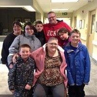 Family group in hospital hallway smiling together